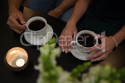 Mid section of couple having coffee