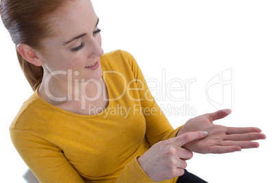 High angle view of young businesswoman gesturing on imaginary product