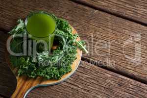 Mustard greens and juice on wooden board