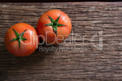 Fresh wet tomatoes on wooden table