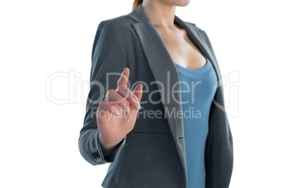 Mid section of businesswoman using imaginary interface