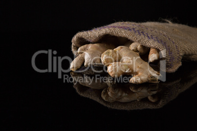 Ginger in sack on black background