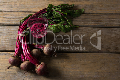 Beetroot and beetroot juice on wooden table