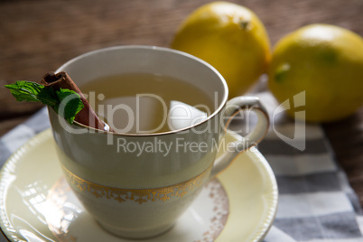 Cup of tea with lemon and cinnamon stick