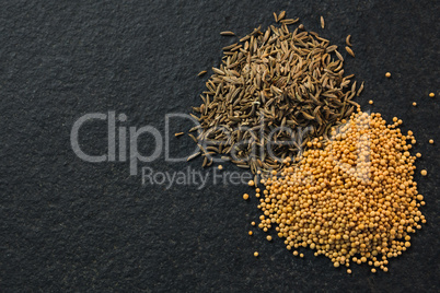 Cumin seeds and spice on black background