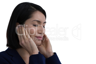 Businesswoman listening music on headphones