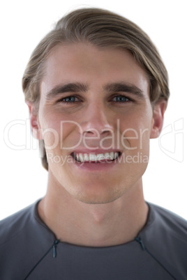 Portrait of smiling young businessman against white background