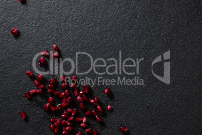 Pomegranate seeds on black background