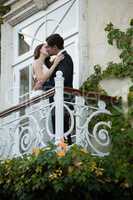 Low angle view of couple kissing while standing in balcony