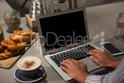 Woman using laptop at table