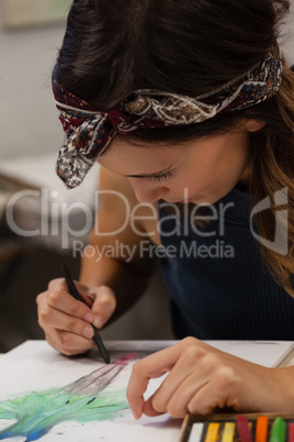 Woman drawing on book in drawing class