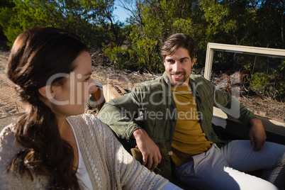 Man looking at woman in off road vehicle
