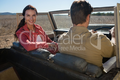 Portrait of woman sitting by man in off road vehicle