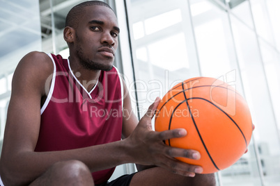 Confident player holding basketball