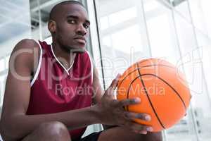 Confident player holding basketball