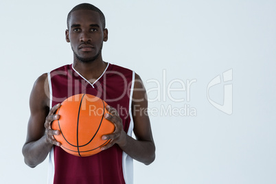 Confident player holding basketball