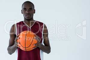 Confident player holding basketball