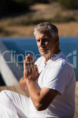 Portrait of confident man practicing yoga