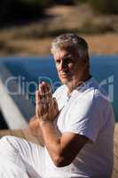 Portrait of confident man practicing yoga