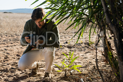 Man holding camera on field