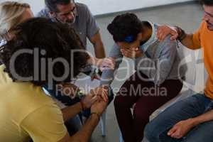 High angle view of friends consoling woman