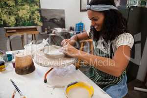 Happy woman molding clay