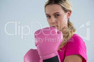 Portrait of young woman with boxing gloves