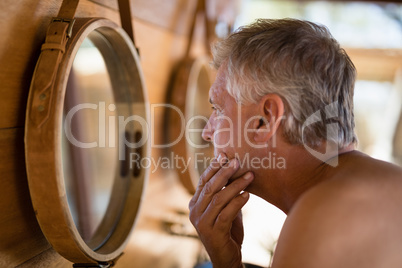 Man looking at mirror in cottage