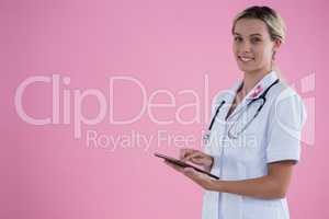 Portrait of smiling female doctor holding tablet computer