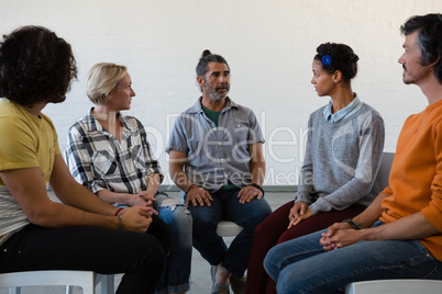 Friends looking at man during discussion