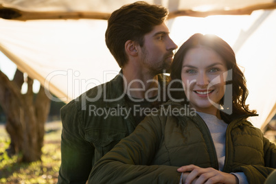 Portrait of smiling woman with man in tent