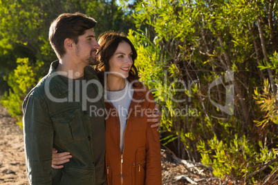 Couple standing by trees