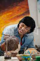 Woman painting a bowl