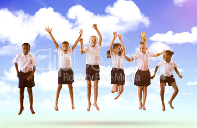 Composite image of full length of students in school uniforms jumping