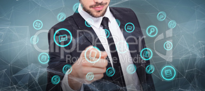 Composite image of smart businessman in suit pointing at camera