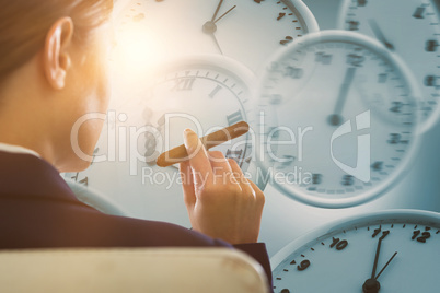 Composite image of businesswoman holding cigar