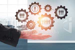 Composite image of businessman holding hand out in presentation
