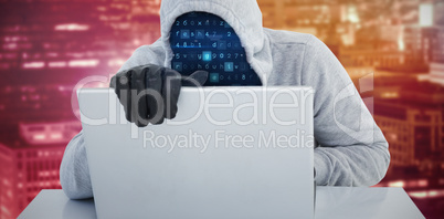 Composite image of hiker in gray hoodie and gloves using laptop