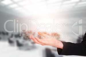 Composite image of businesswomans arm presenting