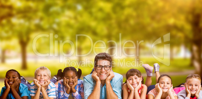 Composite image of portrait of teacher lying down with students