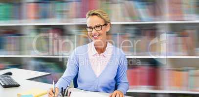 Composite image of portrait of teacher writing on book