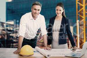 Composite image of portrait of architects standing at table