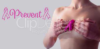 Composite image of nude woman with breast cancer ribbon