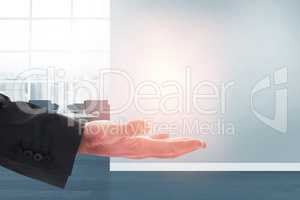 Composite image of businessman holding hand out in presentation