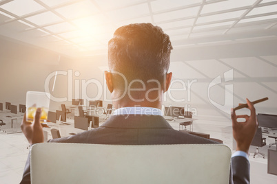 Composite image of rear view of businessman holding whisky glass and cigar