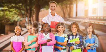 Composite image of portrait of students with teacher holding files