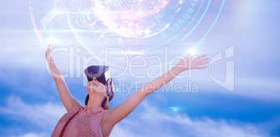 Composite image of woman with arms raised looking through virtual reality simulator against white ba