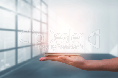 Composite image of hand holding mobile phone against white background