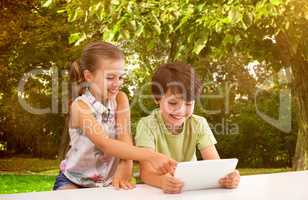 Composite image of boy with sister using digital tablet