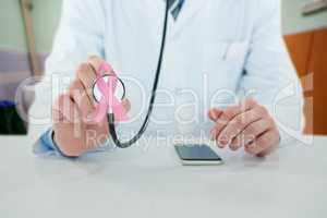 Composite image of midsection of doctor holding stethoscope
